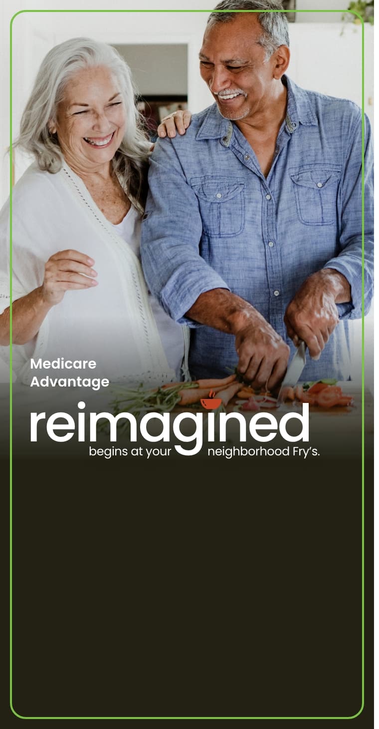 Happy couple chopping vegetables