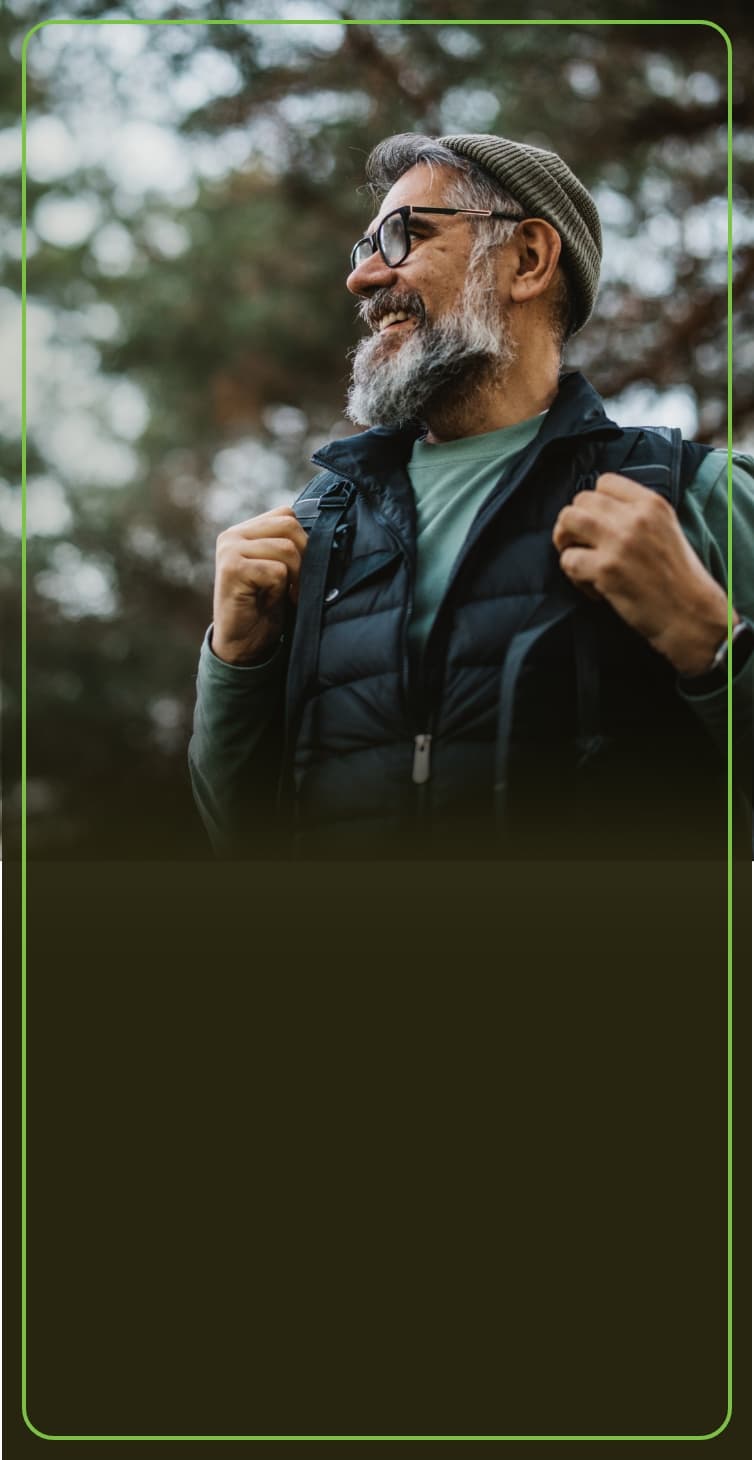 Man smiling as he heads out for a hike